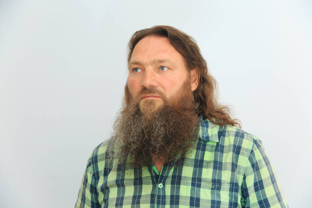 istock Man with a long beard and long hair looks away 1622671426