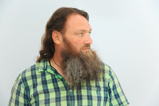 Profile of a man with a long beard and hair