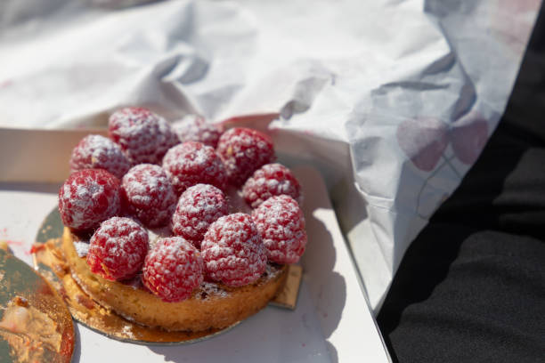 close-up of a little cake with raspberries on a paper