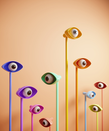 Abstract digital generated eyes looking around and the yellow one standing out from the crowd. (3d render)