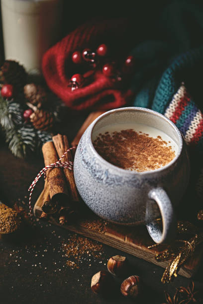 istock Hot milk with spices, warm shawl and Christmas decorations on rustic background. Copy space 1622685334