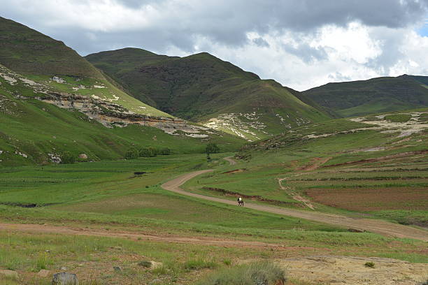 Mounted Sotho Man riding away into Lesotho Landscape.