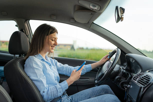 istock Young woman endangers safety by using her phone while driving 1622725044
