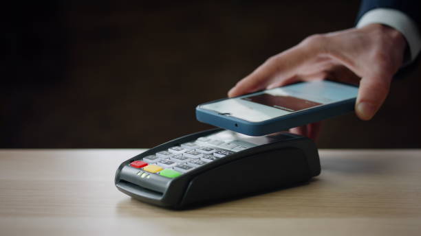 istock Cashless payment using smartphone on modern bank terminal indoors close up. 1622735291