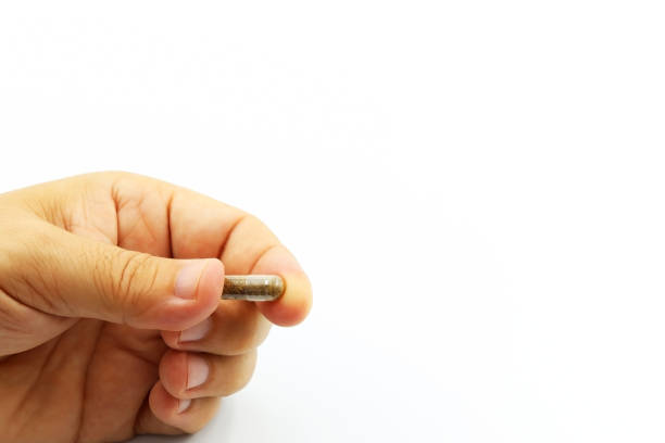istock Hand holding a capsule with microbiota, probiotics or lyophilized microorganisms for fecal transplantation. 1622735800