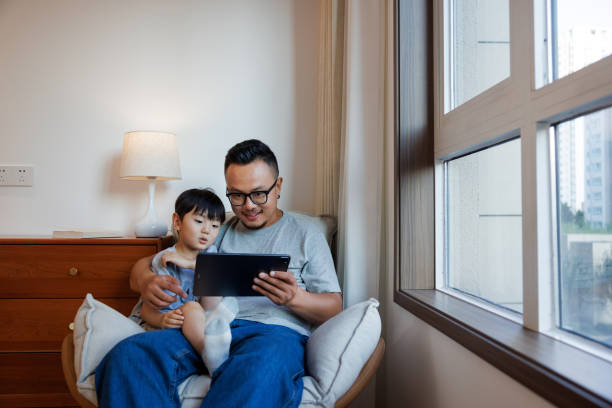 istock Asian fathers use digital tablets with their sons to watch videos 1622736853