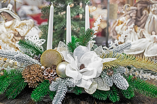 white christmas flower with candles and christmas tree branches. Christmas