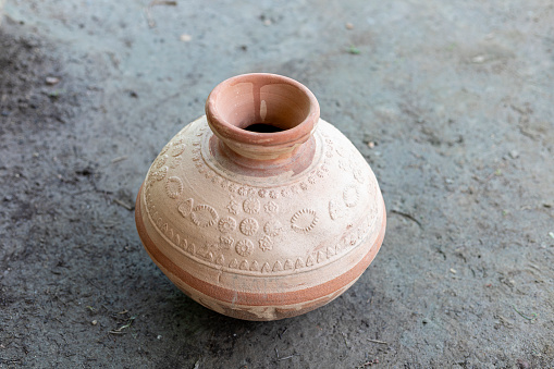 Handmade clay water pot closeup. selective focus.