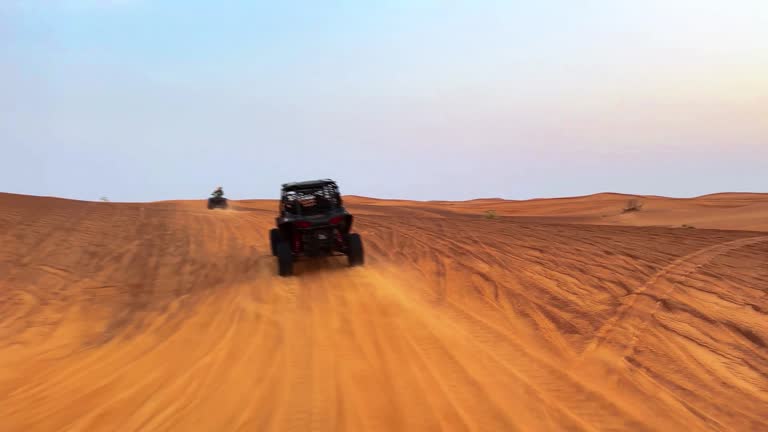 Riding buggies in the desert during sunset