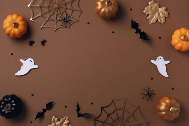 istock Halloween party decorations from pumpkins, bats, spider web and ghosts top view. Happy halloween holiday greeting card flat lay. 1622765331