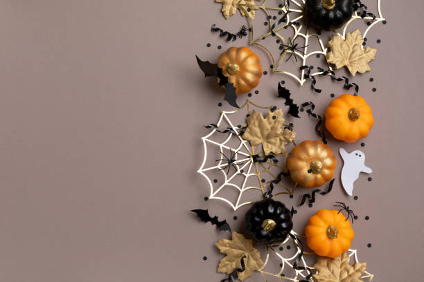 istock Halloween party decorations from pumpkins, bats, spider web and ghosts top view. Happy halloween holiday greeting card or flyer invitation concept. 1622767388