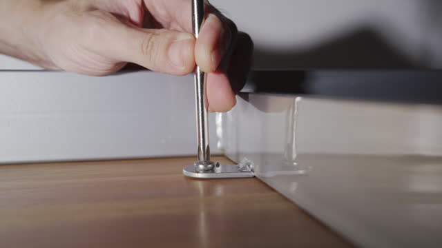 Assembling wooden table with screwdriver