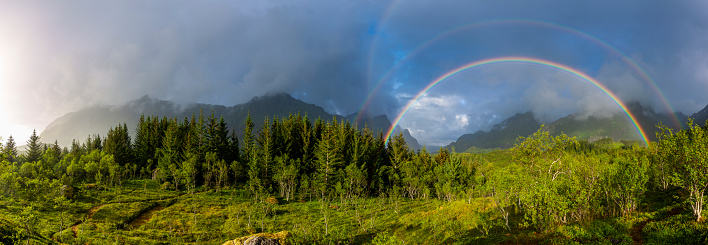 Rainbow over wooded landscape and hills