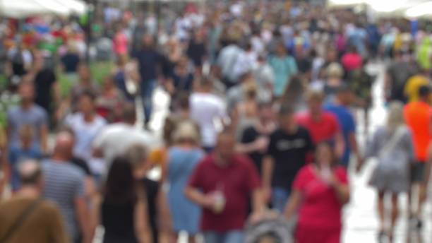 istock Anonymous Crowd Walking on City Street Fast Motion Bokeh Shot 1622796615