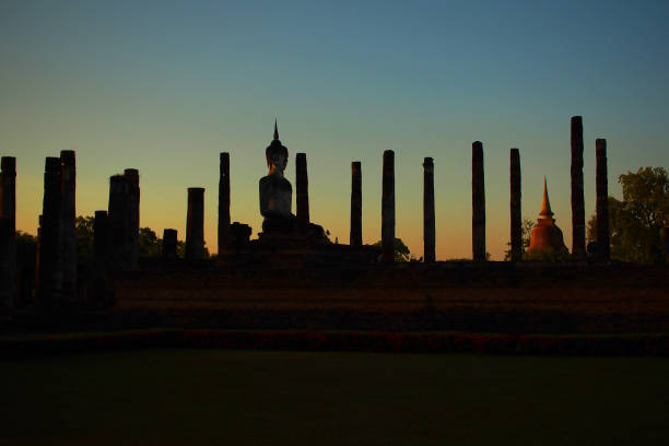 sihlhouette of a Buddha images in ruins of a temple inside the World Heritage Site, Sukhothai Historical Park, Thailand. used for illustration