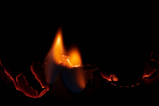 istock burning paper, glowing edge of paper on a black background 1622820053