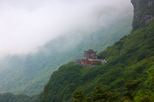 This Buddha Worship Terrace is located halfway up Fanjing Mountain, surrounded by mountains, and is a 270-degree viewing platform. Fanjingshan is a sacred mountain in Chinese Buddhism, considered to be the bodhimaṇḍa of the Maitreya Buddha. It became a UNESCO World Heritage Site in 2018.  It is the highest peak of the Wuling Mountains in Tongren, Guizhou province. It hosts two temples on the top of the mountain, which is very incredible.