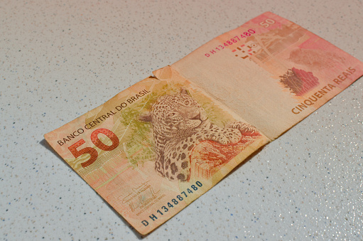 Detail of 50 reais banknote from Brazil, highlighted in Brazilian currency, perfect for financial concepts. Casa da Moeda do Brasil, representing the Brazilian monetary value in evidence