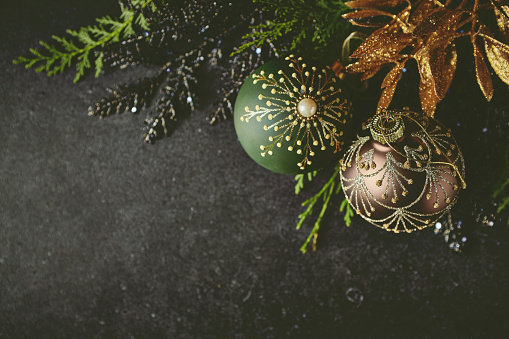 An arrangement of vintage Christmas decorations on black background. Flat lay. Copy space