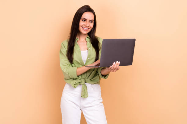 istock Portrait of positive nice lady hold use wireless apple netbook networking write email isolated on beige color background 1622852006