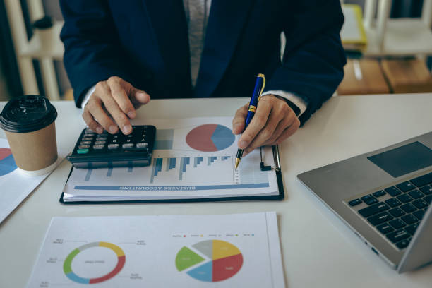istock Businessman analyzing investment chart and pressing calculator button to calculate documents Accounting close up image of financial documents on digital tablet 1622857601