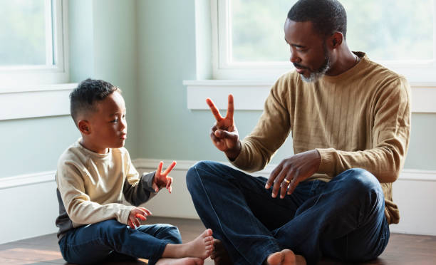 istock Boy playing with father at home, counting with fingers 1622867457