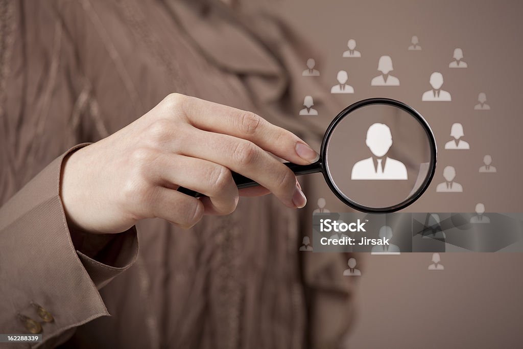 Human resources and CRM Human resources, CRM and social media concept - officer looking for employee represented by icon. Gender discrimination in employees selection. Magnifying Glass Stock Photo