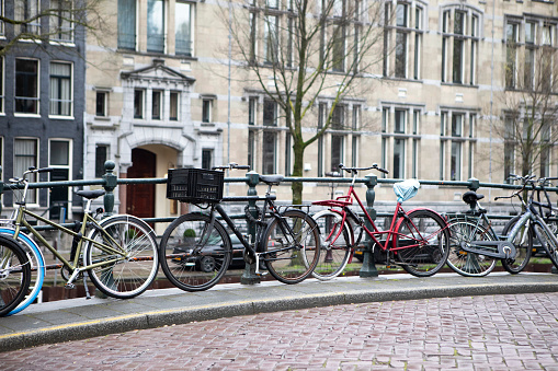 Bicycles in a row by a canal in Amsterdam
