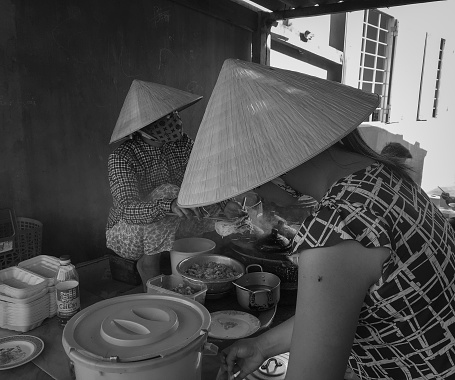Mui Ne, Vietnam - Mar 19, 2016. Women cooking street foods in Mui Ne township, Phan Thiet, Vietnam.