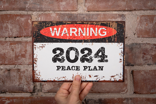 2024 Peace Plan Concept. warning sign with text on brick wall background.