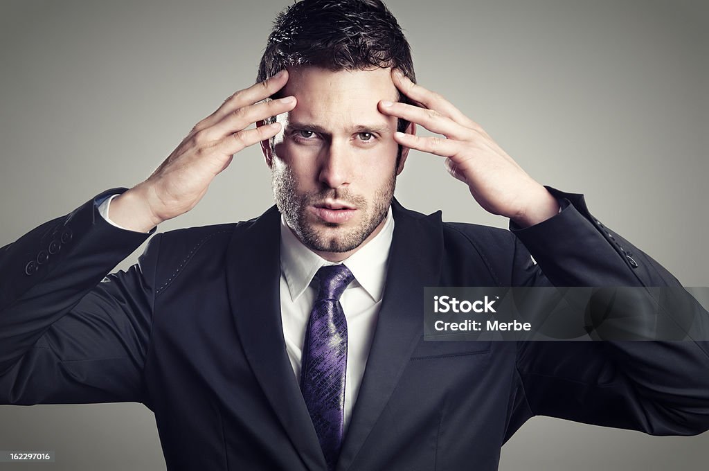 Stressed Businessman with his hands in the head, he's stressed and worried. Accidents and Disasters Stock Photo