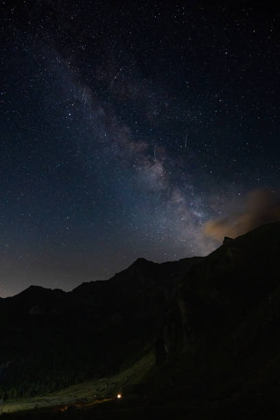 istock Milky way view rising up from dark mountains. 1622994460