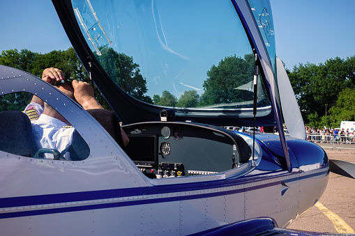 Ukraine, Cherkassy - June 26, 2018:The pilot sits in the open cockpit of a light aircraft.