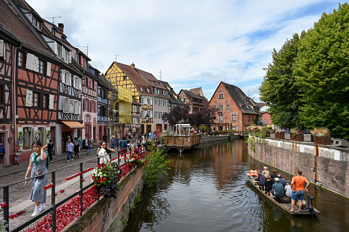 Colmar, France, July 26, 2023 - The canal with tourist boats in the historic old town Petite Venise of Colmar.
