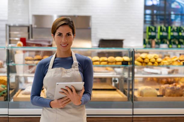 istock Saleswoman working at a bakery and using a digital tablet 1623085093