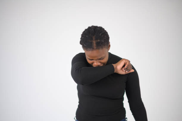 istock Woman Coughing Sneezing into elbow 1623088050
