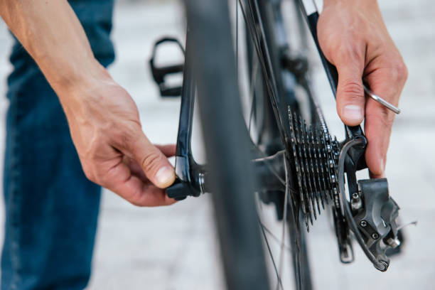 istock Close up of mans hands fixing a problem with bike tire 1623093303
