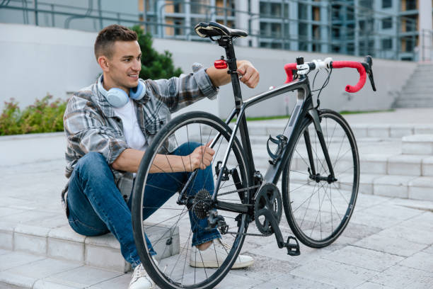 istock Good-looking young man fixing a problem with a bike tire 1623093849