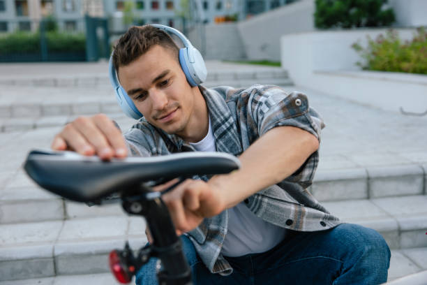 istock Smiling young man fixing a problem with the bike 1623096086