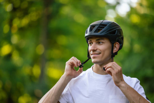 istock Young handsome cyclist putting on his protective hemlet 1623096641