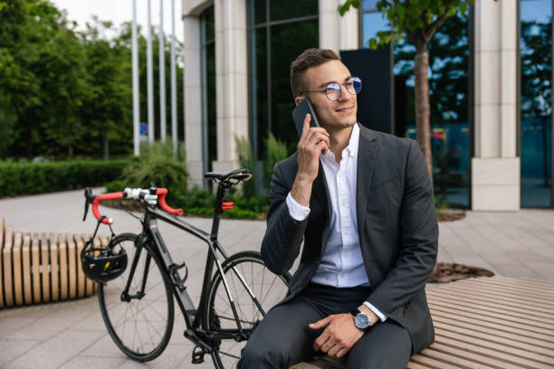 istock Young man in elegant suit talking on the phone and looking contented 1623096673