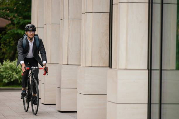 istock Young smiling businessman on a bike 1623097215