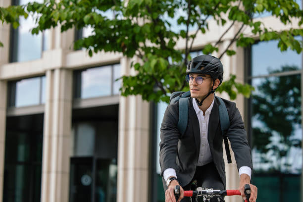 istock Man riding a bike in the office area 1623097775