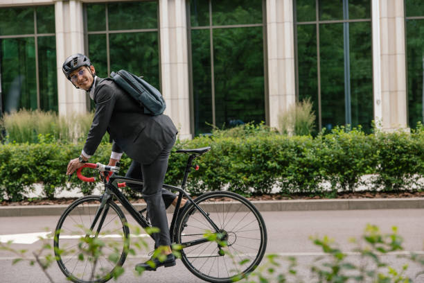 istock Man in hemlet and with a backpack riding a bike 1623098987