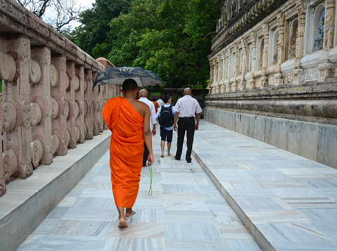 Bodh Gaya, India - Jul 9, 2015. People walking at Mahabodhi Temple Complex in Bodhgaya, India. The Mahabodhi Vihar, a UNESCO World Heritage Site, is a Buddhist temple.