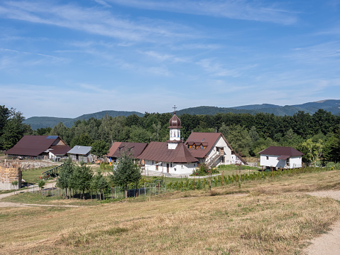 Bumbesti-Jiu, Gorj, Romania – July 29, 2023: The church and hermitage of St. John the Baptizer, at the foothill of the mountain Parang. It is a hermitage of old rite Christian monks.