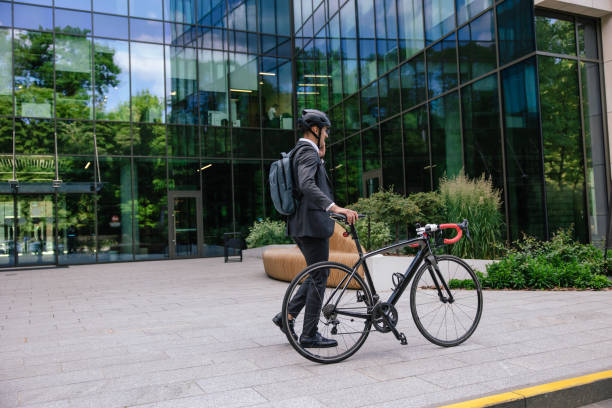 istock Man on a bike in the office area 1623100192