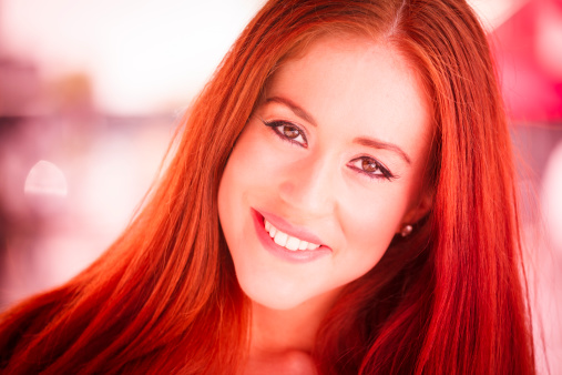 Portrait of attractive young woman with red hair.