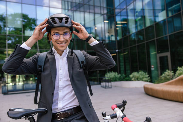 istock Smiling businessman putting on a protective hemlet 1623101272