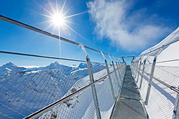 suspension bridge at mount titlis, swiss alps, switzerland. it´s the highest suspension bridge in europe at 3200m above sea level.
